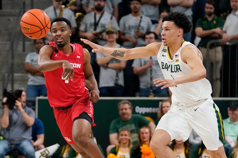 Feb 24, 2024; Waco, Texas, USA; Baylor Bears guard Ja'Kobe Walter (4) passes the ball past Baylor Bears guard Miro Little (1) during the first half at Paul and Alejandra Foster Pavilion. Mandatory Credit: Raymond Carlin III-USA TODAY Sports