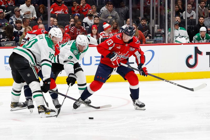 Oct 17, 2024; Washington, District of Columbia, USA; Washington Capitals left wing Jakub Vrana (13) battles for the puck with Dallas Stars defenseman Brendan Smith (2) and Stars center Oskar Bäck (10) in the second period at Capital One Arena. Mandatory Credit: Geoff Burke-Imagn Images