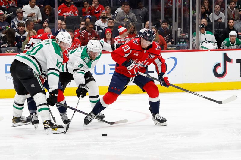 Oct 17, 2024; Washington, District of Columbia, USA; Washington Capitals left wing Jakub Vrana (13) battles for the puck with Dallas Stars defenseman Brendan Smith (2) and Stars center Oskar Bäck (10) in the second period at Capital One Arena. Mandatory Credit: Geoff Burke-Imagn Images