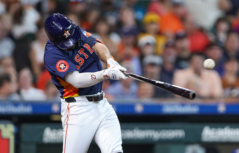 Jul 14, 2024; Houston, Texas, USA; Houston Astros second baseman Jose Altuve (27) hits a single during the third inning against the Texas Rangers at Minute Maid Park. Mandatory Credit: Troy Taormina-USA TODAY Sports