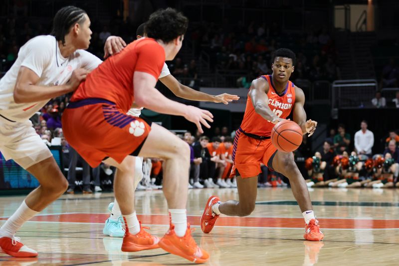 Jan 3, 2024; Coral Gables, Florida, USA; Clemson Tigers forward RJ Godfrey (10) passes the basketball to forward Ian Schieffelin (4) against the Miami Hurricanes during the first half at Watsco Center. Mandatory Credit: Sam Navarro-USA TODAY Sports