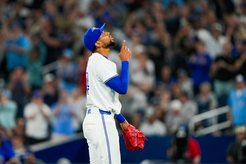 Jun 29, 2024; Toronto, Ontario, CAN; Toronto Blue Jays pitcher Jose Cuas (74) points to the sky after defeating the New York Yankees at Rogers Centre. Mandatory Credit: Kevin Sousa-USA TODAY Sports