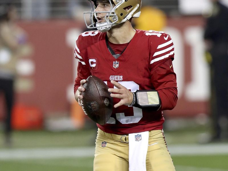 San Francisco 49ers quarterback Brock Purdy (13) runs outside the pocket during the NFC Championship NFL football game against the Detroit Lions in Santa Clara, Calif., Sunday, Jan. 28, 2024. (AP Photo/Scot Tucker)