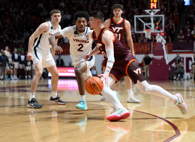 Feb 4, 2023; Blacksburg, Virginia, USA;  Virginia Tech Hokies guard Hunter Cattoor (0) dribbles around Virginia Tech Hokies guard Michael Collins Jr. (2) in the second half at Cassell Coliseum. Mandatory Credit: Lee Luther Jr.-USA TODAY Sports