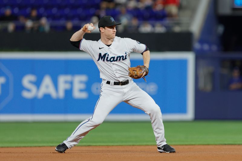 Jun 19, 2023; Miami, Florida, USA; Miami Marlins shortstop Joey Wendle (18) throws the baseball to first baseman Garrett Cooper (not pictured) to retire Toronto Blue Jays right fielder George Springer (not pictured) during the first inning at loanDepot Park. Mandatory Credit: Sam Navarro-USA TODAY Sports