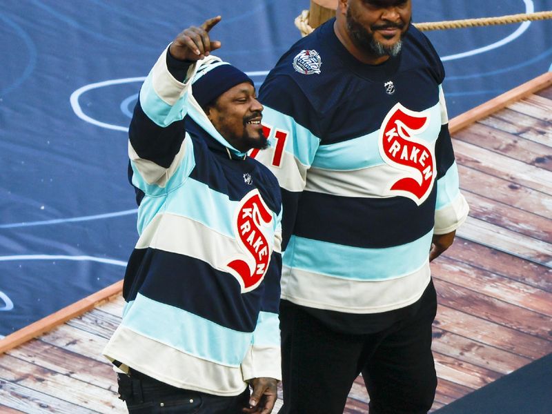 Jan 1, 2024; Seattle, Washington, USA; Former Seattle Seahawk players Marshawn Lynch, left, and Walter Jones are introduced to the crowd during the second period intermission in the 2024 Winter Classic ice hockey game between the Vegas Golden Knights and Seattle Kraken at T-Mobile Park. Mandatory Credit: Joe Nicholson-USA TODAY Sports