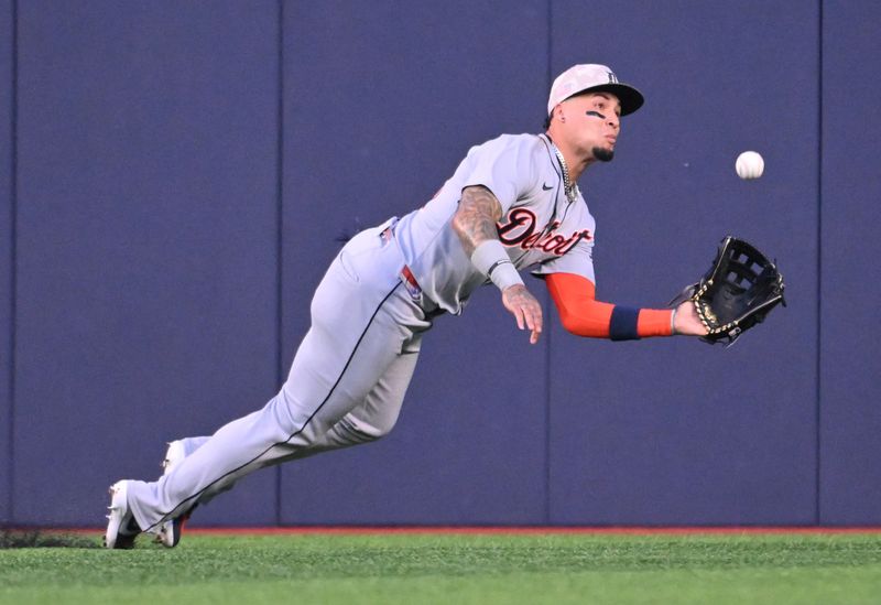 May 16, 2025; Toronto, Ontario, CAN;  Detroit Tigers center fielder Javier Baez (28) catches a fly ball hit by Toronto Blue Jays right fielder Nathan Lukes (not pictured) in the second inning at Rogers Centre. Mandatory Credit: Dan Hamilton-Imagn Images