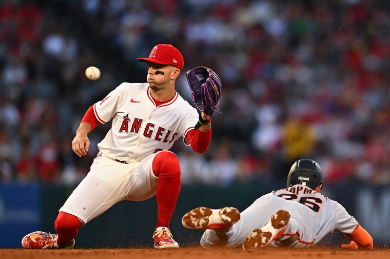 Apr 19, 2025; Anaheim, California, USA; San Francisco Giants third baseman Matt Chapman (26) steals second base against Los Angeles Angels shortstop Zach Neto (9) during the fourth inning at Angel Stadium. Mandatory Credit: Jonathan Hui-Imagn Images