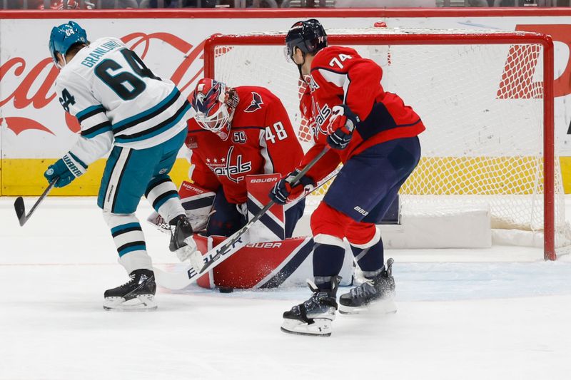 Dec 3, 2024; Washington, District of Columbia, USA; Washington Capitals goaltender Logan Thompson (48) makes a save in front of San Jose Sharks center Mikael Granlund (64) and Capitals defenseman John Carlson (74) in the first period at Capital One Arena. Mandatory Credit: Geoff Burke-Imagn Images