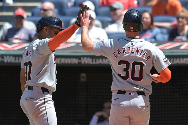 May 8, 2024; Cleveland, Ohio, USA; Detroit Tigers second baseman Andy Ibanez (77) and right fielder Kerry Carpenter (30) celebrate after scoring during the fourth inning against the Cleveland Guardians at Progressive Field. Mandatory Credit: Ken Blaze-USA TODAY Sports