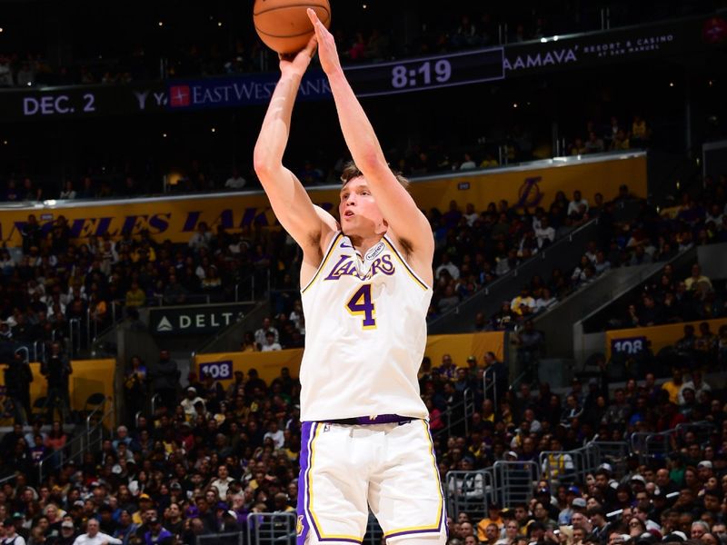 LOS ANGELES, CA - NOVEMBER 23: Dalton Knecht #4 of the Los Angeles Lakers shoots a three point basket during the game against the Denver Nuggets on November 23, 2024 at Crypto.Com Arena in Los Angeles, California. NOTE TO USER: User expressly acknowledges and agrees that, by downloading and/or using this Photograph, user is consenting to the terms and conditions of the Getty Images License Agreement. Mandatory Copyright Notice: Copyright 2024 NBAE (Photo by Adam Pantozzi/NBAE via Getty Images)