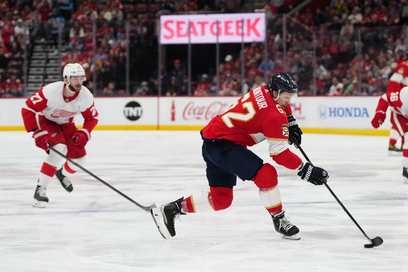 Jan 17, 2024; Sunrise, Florida, USA; Florida Panthers defenseman Brandon Montour (62) plays the puck against the Detroit Red Wings during the second period at Amerant Bank Arena. Mandatory Credit: Jasen Vinlove-USA TODAY Sports