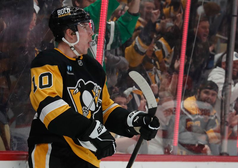 Oct 18, 2024; Pittsburgh, Pennsylvania, USA;  Pittsburgh Penguins left wing Drew O'Connor (10) reacts after scoring a goal against the Carolina Hurricanes during the first period at PPG Paints Arena. Mandatory Credit: Charles LeClaire-Imagn Images