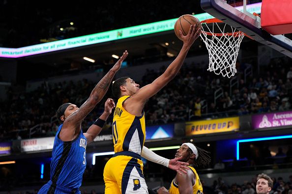 INDIANAPOLIS, INDIANA - NOVEMBER 19: Tyrese Haliburton #0 of the Indiana Pacers shoots against Paolo Banchero #5 of the Orlando Magic during the second half of an NBA basketball game at Gainbridge Fieldhouse on November 19, 2023 in Indianapolis, Indiana. NOTE TO USER: User expressly acknowledges and agrees that, by downloading and or using this photograph, User is consenting to the terms and conditions of the Getty Images License Agreement. (Photo by Jeff Dean/Getty Images)