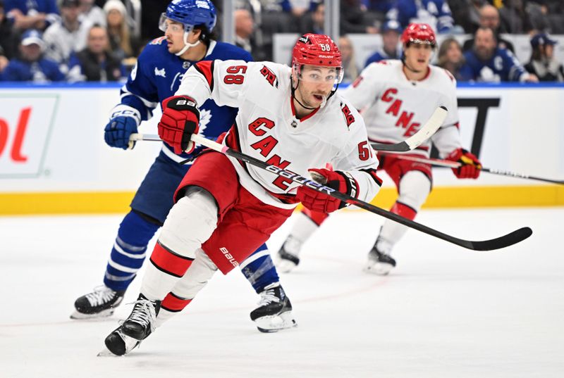 Dec 30, 2023; Toronto, Ontario, CAN; Carolina Hurricanes forward Michael Bunting (58) pursues the play against the Toronto Maple Leafs in the first period at Scotiabank Arena. Mandatory Credit: Dan Hamilton-USA TODAY Sports