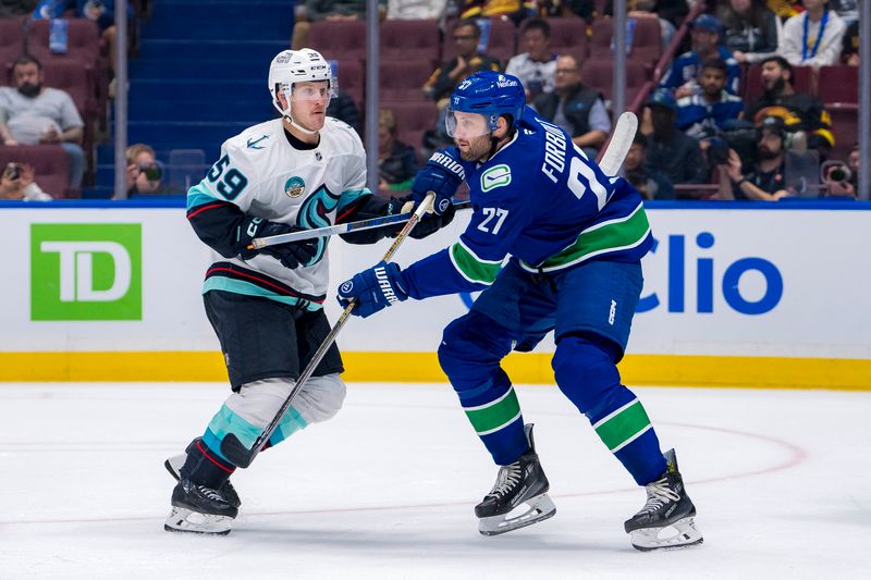 Sep 24, 2024; Vancouver, British Columbia, CAN; Vancouver Canucks defenseman Derek Forbort (27) battles with Seattle Kraken defenseman Jakub Fibigr (59) during the second period at Rogers Arena. Mandatory Credit: Bob Frid-Imagn Images