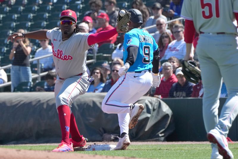 Feb 24, 2026; Jupiter, Florida, USA;  Philadelphia Phillies first baseman Felix Reyes (82) stretches to make the catch to get Miami Marlins shortstop Xavier Edwards (9) out in the first inning at Roger Dean Chevrolet Stadium. Mandatory Credit: Jim Rassol-Imagn Images
