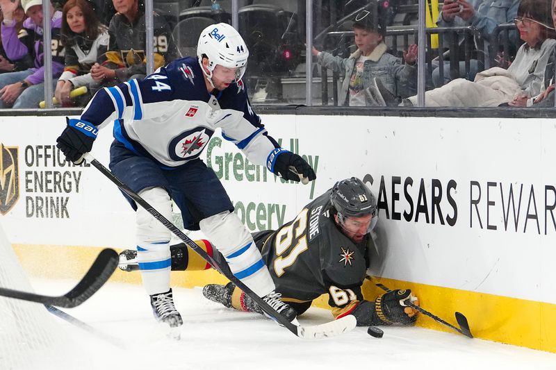 Apr 3, 2025; Las Vegas, Nevada, USA; Vegas Golden Knights right wing Mark Stone (61) loses the puck to Winnipeg Jets defenseman Josh Morrissey (44) after losing an edge during the second period at T-Mobile Arena. Mandatory Credit: Stephen R. Sylvanie-Imagn Images