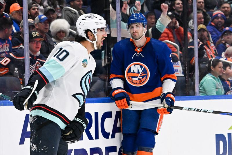 Feb 13, 2024; Elmont, New York, USA; Seattle Kraken center Matty Beniers (10) celebrates his goal against the New York Islanders during the first period at UBS Arena. Mandatory Credit: Dennis Schneidler-USA TODAY Sports