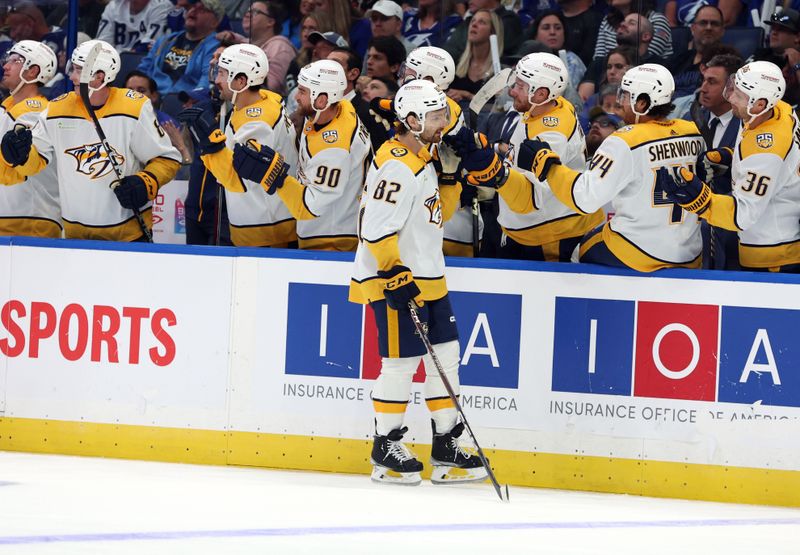 Oct 10, 2023; Tampa, Florida, USA; Nashville Predators center Tommy Novak (82) is congratulated after he scored a goal against the Tampa Bay Lightning during the third period at Amalie Arena. Mandatory Credit: Kim Klement Neitzel-USA TODAY Sports