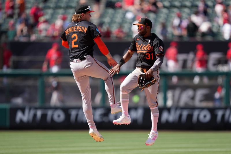 May 11, 2025; Anaheim, California, USA; Baltimore Orioles shortstop Gunnar Henderson (2) and center fielder Cedric Mullins (31) celebrate after the game against the Los Angeles Angels  at Angel Stadium. Mandatory Credit: Kirby Lee-Imagn Images