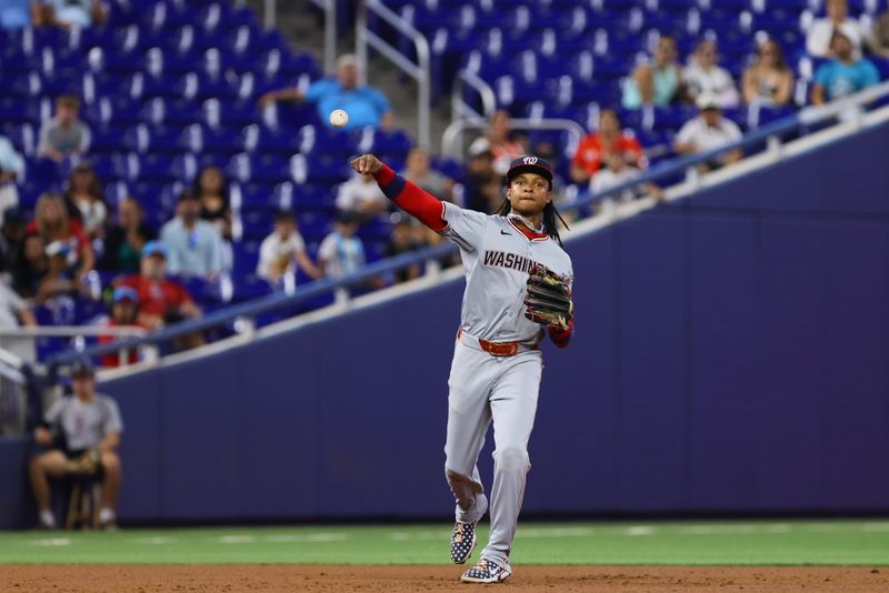 Apr 27, 2024; Miami, Florida, USA; Washington Nationals shortstop CJ Abrams (5) throws to first base against the Miami Marlins during the third inning at loanDepot Park. Mandatory Credit: Sam Navarro-USA TODAY Sports