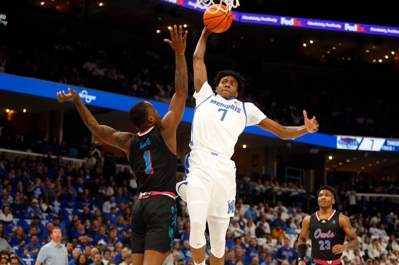 Feb 25, 2024; Memphis, Tennessee, USA; Memphis Tigers forward Nae'Qwan Tomlin (7) drives to the basket as Florida Atlantic Owls guard Johnell Davis (1) defends during the first half at FedExForum. Mandatory Credit: Petre Thomas-USA TODAY Sports