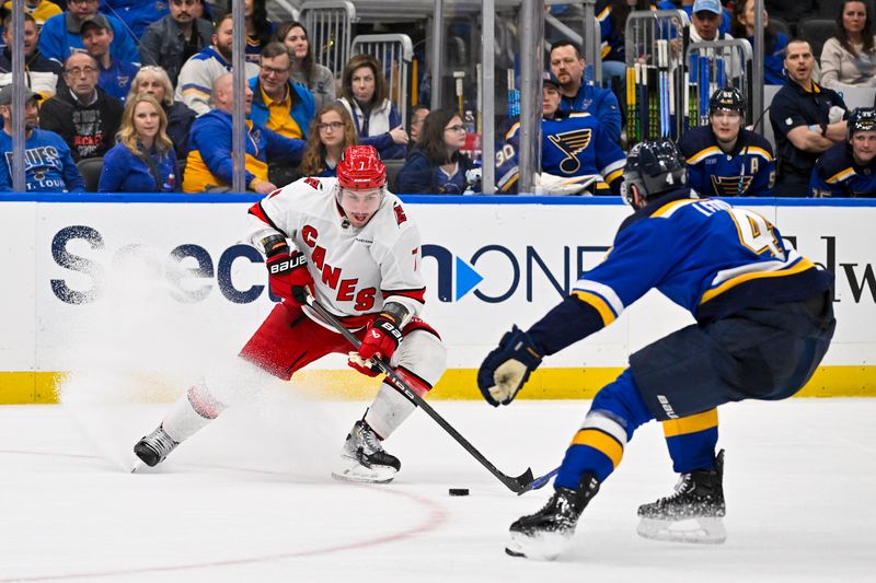 Apr 12, 2024; St. Louis, Missouri, USA;  Carolina Hurricanes defenseman Dmitry Orlov (7) controls the puck against the St. Louis Blues during the third period at Enterprise Center. Mandatory Credit: Jeff Curry-USA TODAY Sports