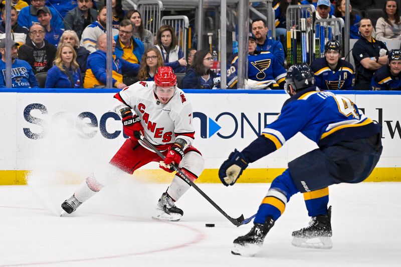 Apr 12, 2024; St. Louis, Missouri, USA;  Carolina Hurricanes defenseman Dmitry Orlov (7) controls the puck against the St. Louis Blues during the third period at Enterprise Center. Mandatory Credit: Jeff Curry-USA TODAY Sports