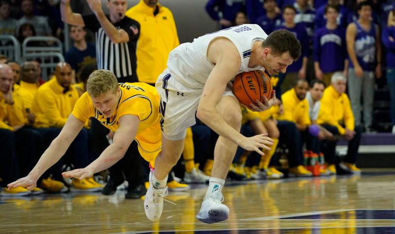 Feb 2, 2023; Evanston, Illinois, USA; Michigan Wolverines forward Youssef Khayat (24) fouls Northwestern Wildcats forward Robbie Beran (31) during the first half at Welsh-Ryan Arena. Mandatory Credit: David Banks-USA TODAY Sports