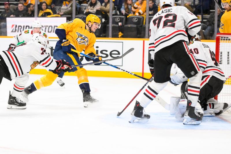 Jan 16, 2025; Nashville, Tennessee, USA;  Nashville Predators center Colton Sissons (10) takes a shot on goal against the Chicago Blackhawks during the third period at Bridgestone Arena. Mandatory Credit: Steve Roberts-Imagn Images