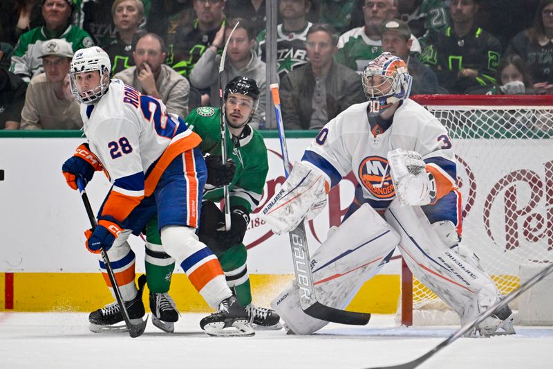 Feb 26, 2024; Dallas, Texas, USA; Dallas Stars center Logan Stankoven (11) skates between New York Islanders defenseman Alexander Romanov (28) and goaltender Ilya Sorokin (30) as he looks for the puck during the first period at the American Airlines Center. Mandatory Credit: Jerome Miron-USA TODAY Sports