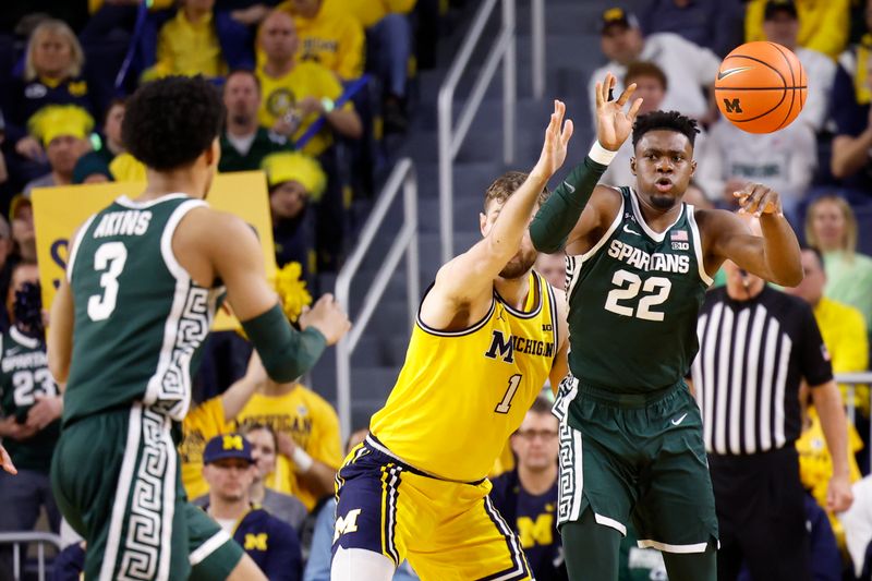 Feb 18, 2023; Ann Arbor, Michigan, USA;  Michigan State Spartans center Mady Sissoko (22) passes the ball to guard Jaden Akins (3) against Michigan Wolverines center Hunter Dickinson (1) in the first half at Crisler Center. Mandatory Credit: Rick Osentoski-USA TODAY Sports