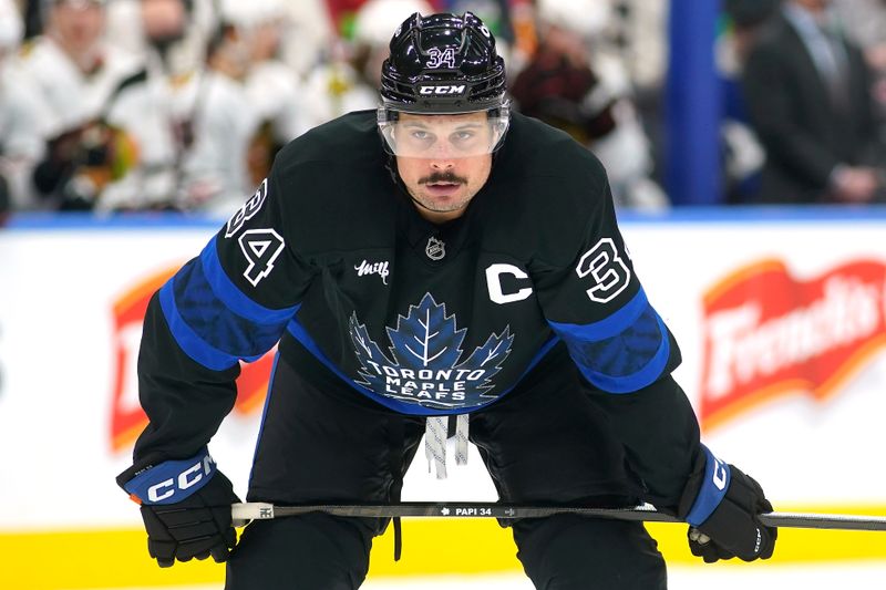 Dec 2, 2024; Toronto, Ontario, CAN; Toronto Maple Leafs forward Auston Matthews (34) gets set on a face-off against the Chicago Blackhawks during the third period at Scotiabank Arena. Mandatory Credit: John E. Sokolowski-Imagn Images