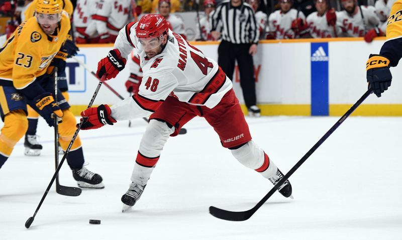 Apr 6, 2023; Nashville, Tennessee, USA; Carolina Hurricanes left wing Jordan Martinook (48) skates the puck into the offensive zone during the second period against the Nashville Predators at Bridgestone Arena. Mandatory Credit: Christopher Hanewinckel-USA TODAY Sports