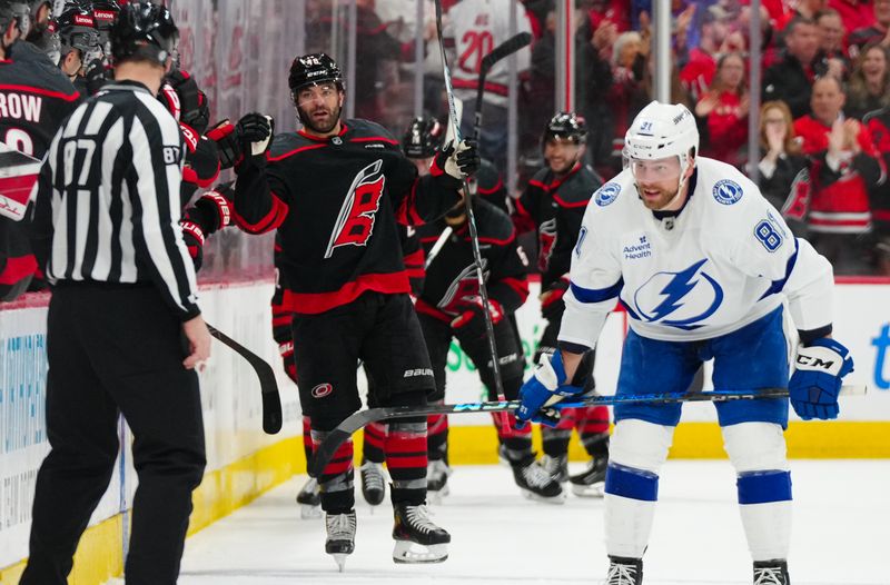 Mar 11, 2025; Raleigh, North Carolina, USA;  Carolina Hurricanes left wing Jordan Martinook (48) celebrates his goal against the Tampa Bay Lightning during the second period at Lenovo Center. Mandatory Credit: James Guillory-Imagn Images