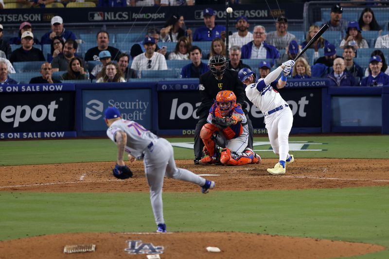 Oct 13, 2024; Los Angeles, California, USA; Los Angeles Dodgers third base Enrique Hernandez (8) hits a single against New York Mets pitcher Jose Butto (70) in the eighth inning during game one of the NLCS for the 2024 MLB Playoffs at Dodger Stadium. Mandatory Credit: Jason Parkhurst-Imagn Images