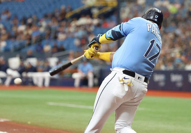 May 28, 2023; St. Petersburg, Florida, USA; Tampa Bay Rays third baseman Isaac Paredes (17) hits an RBI single against the Los Angeles Dodgers during the first inning at Tropicana Field. Mandatory Credit: Kim Klement-USA TODAY Sports