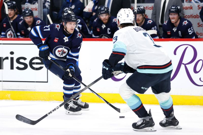 Mar 5, 2024; Winnipeg, Manitoba, CAN; Winnipeg Jets left wing Nikolaj Ehlers (27) skates up the ice towards Seattle Kraken defenseman Will Borgen (3) in the second period at Canada Life Centre. Mandatory Credit: James Carey Lauder-USA TODAY Sports