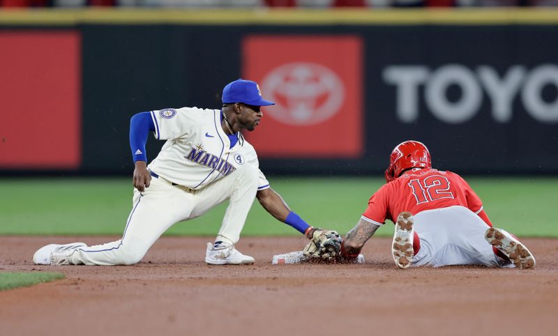 Jun 2, 2024; Seattle, Washington, USA;  Seattle Mariners second baseman Ryan Bliss (1) tags Los Angeles Angels left fielder Kevin Pillar (12) out at second on a steal sttempt during the second inning at T-Mobile Park. Mandatory Credit: John Froschauer-USA TODAY Sports