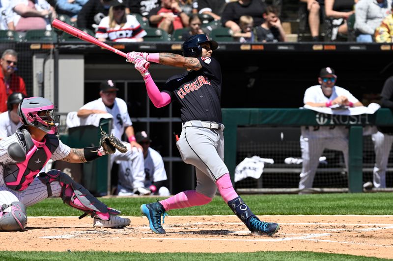 May 12, 2024; Chicago, Illinois, USA;  Cleveland Guardians shortstop Brayan Rocchio (4) hits an RBI sacrifice fly ball against the Chicago White Sox during the third inning at Guaranteed Rate Field. Mandatory Credit: Matt Marton-USA TODAY Sports