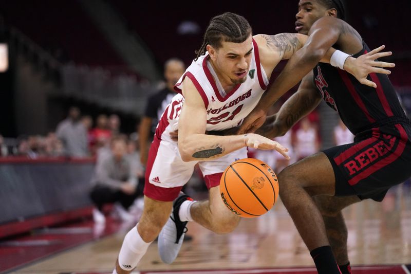 Feb 14, 2024; Fresno, California, USA; Fresno State Bulldogs guard Isaiah Pope (21) drives past UNLV Rebels guard Luis Rodriguez (15) in the second half at the Save Mart Center. Mandatory Credit: Cary Edmondson-USA TODAY Sports