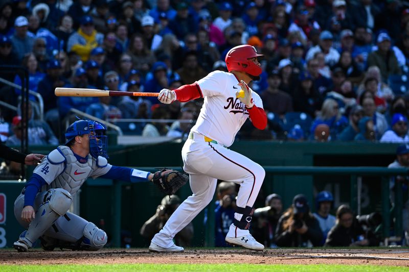 Apr 9, 2025; Washington, District of Columbia, USA; Washington Nationals second base Luis García Jr. (2) hits a RBI sacrifice fly against the Los Angeles Dodgers during the first inning at Nationals Park. Mandatory Credit: Brad Mills-Imagn Images