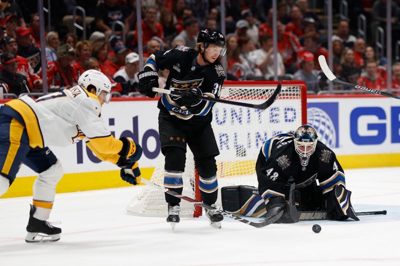 Nov 6, 2024; Washington, District of Columbia, USA; Washington Capitals goaltender Logan Thompson (48) makes a save on Nashville Predators right wing Luke Evangelista (77) in the second period at Capital One Arena. Mandatory Credit: Geoff Burke-Imagn Images