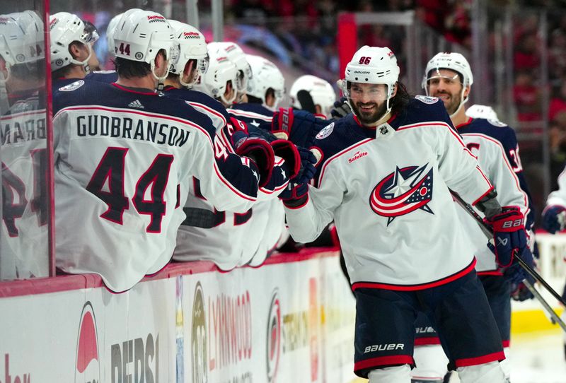 Nov 26, 2023; Raleigh, North Carolina, USA; Columbus Blue Jackets right wing Yegor Chinakhov (59) celebrates his goal against the Carolina Hurricanes during the third period at PNC Arena. Mandatory Credit: James Guillory-USA TODAY Sports