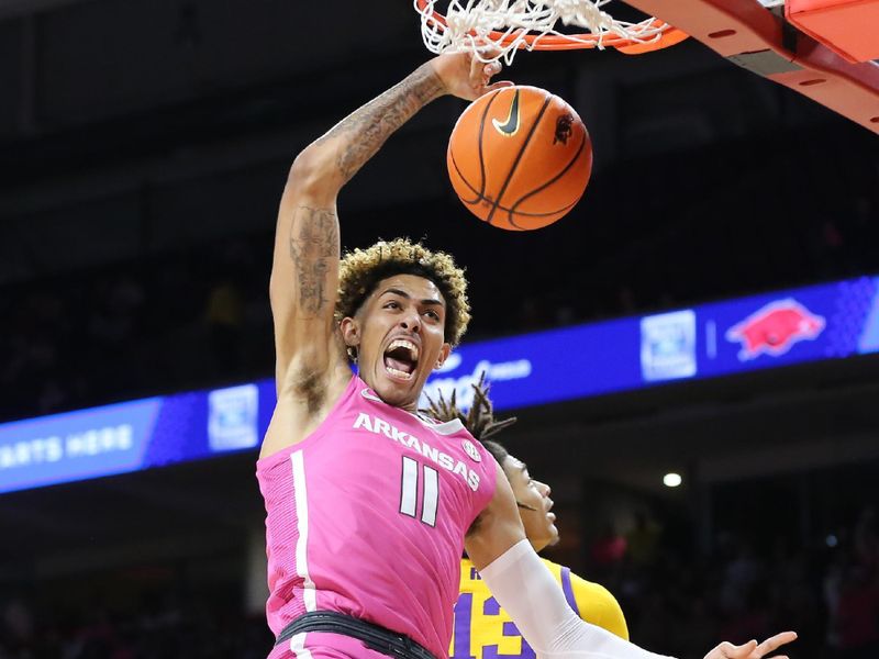 Jan 24, 2023; Fayetteville, Arkansas, USA; Arkansas Razorbacks forward Jalen Graham (11) dunks the ball as LSU Tigers forward Jalen Reed (13) defends during the first half at Bud Walton Arena. Mandatory Credit: Nelson Chenault-USA TODAY Sports