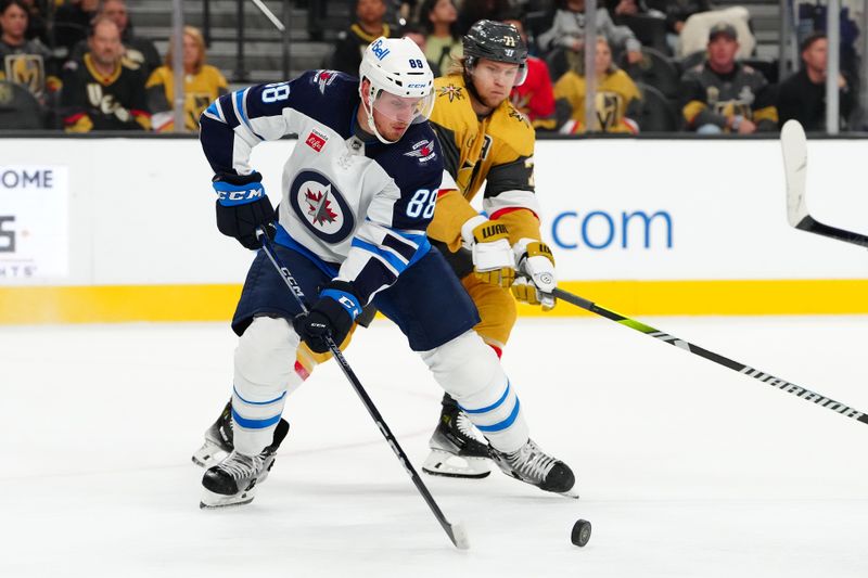 Nov 2, 2023; Las Vegas, Nevada, USA; Winnipeg Jets defenseman Nate Schmidt (88) defends the puck from Vegas Golden Knights center William Karlsson (71) during the first period at T-Mobile Arena. Mandatory Credit: Stephen R. Sylvanie-USA TODAY Sports