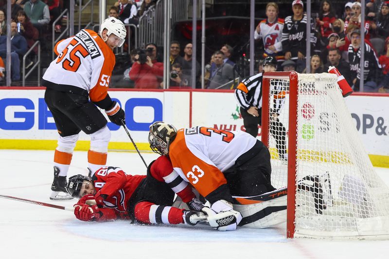 Dec 19, 2023; Newark, New Jersey, USA; New Jersey Devils center Jack Hughes (86) crashes into Philadelphia Flyers goaltender Samuel Ersson (33) during overtime at Prudential Center. Mandatory Credit: Ed Mulholland-USA TODAY Sports