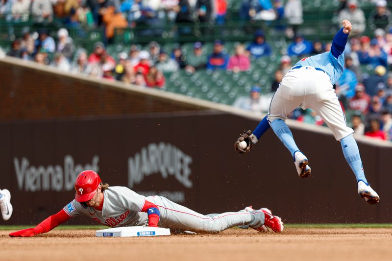 Apr 25, 2025; Chicago, Illinois, USA; Philadelphia Phillies second baseman Bryson Stott (5) steals second base against Chicago Cubs shortstop Dansby Swanson (7) during the first inning at Wrigley Field. Mandatory Credit: Kamil Krzaczynski-Imagn Images