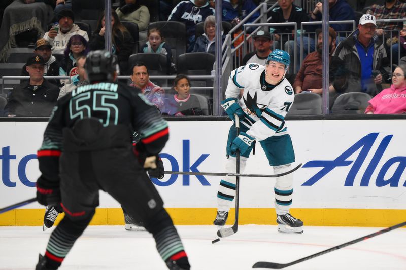 Nov 5, 2025; Seattle, Washington, USA; San Jose Sharks center Macklin Celebrini (71) passes the puck against the Seattle Kraken during the third period at Climate Pledge Arena. Mandatory Credit: Steven Bisig-Imagn Images